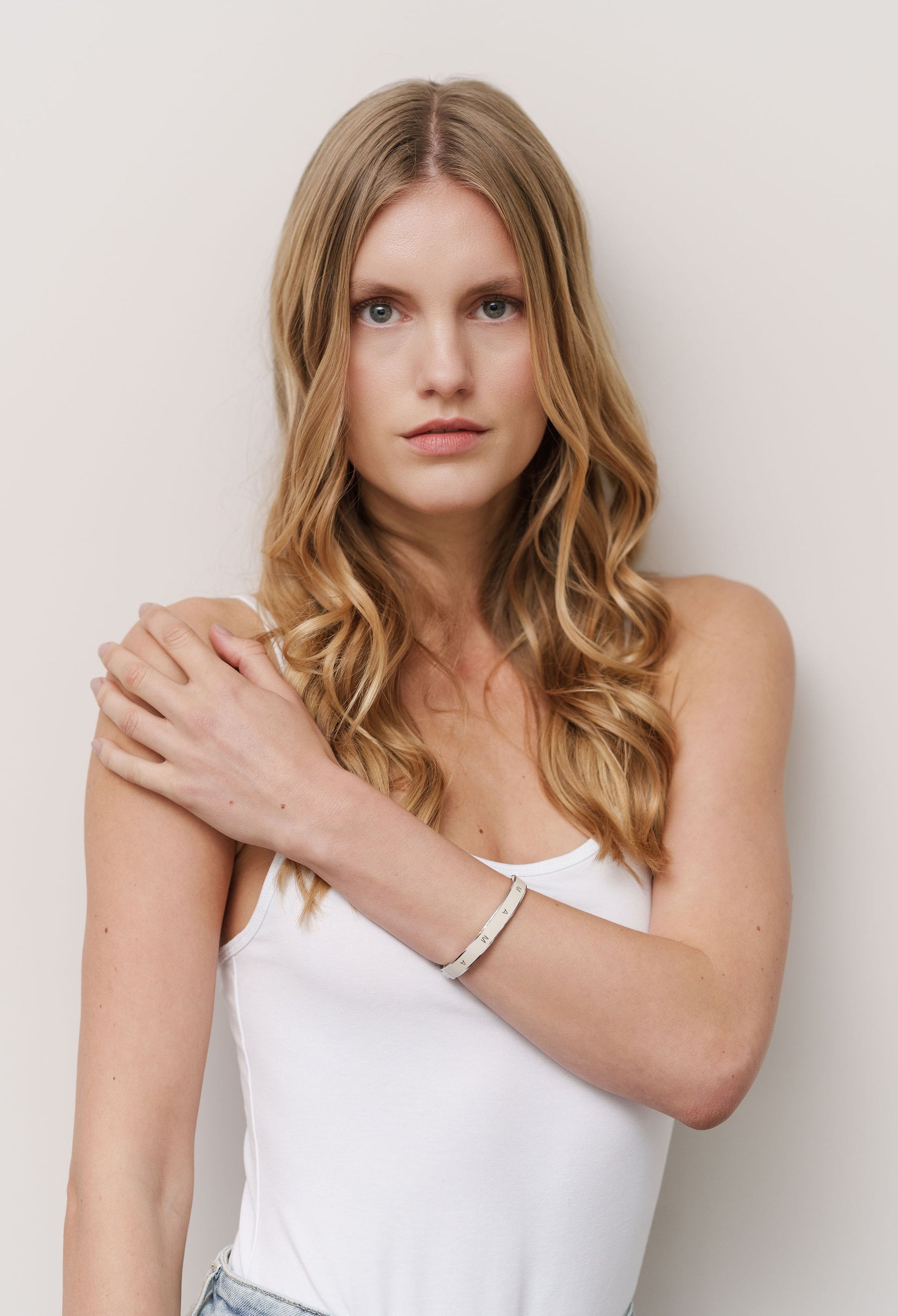 Proud mother wearing her Vivi Coo Mama bracelet, motherhood jewellery