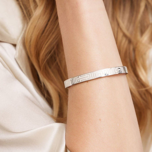 Mother wearing her Vivi Coo Tapuat silver and enamel bracelet, symbolising motherhood and connection.