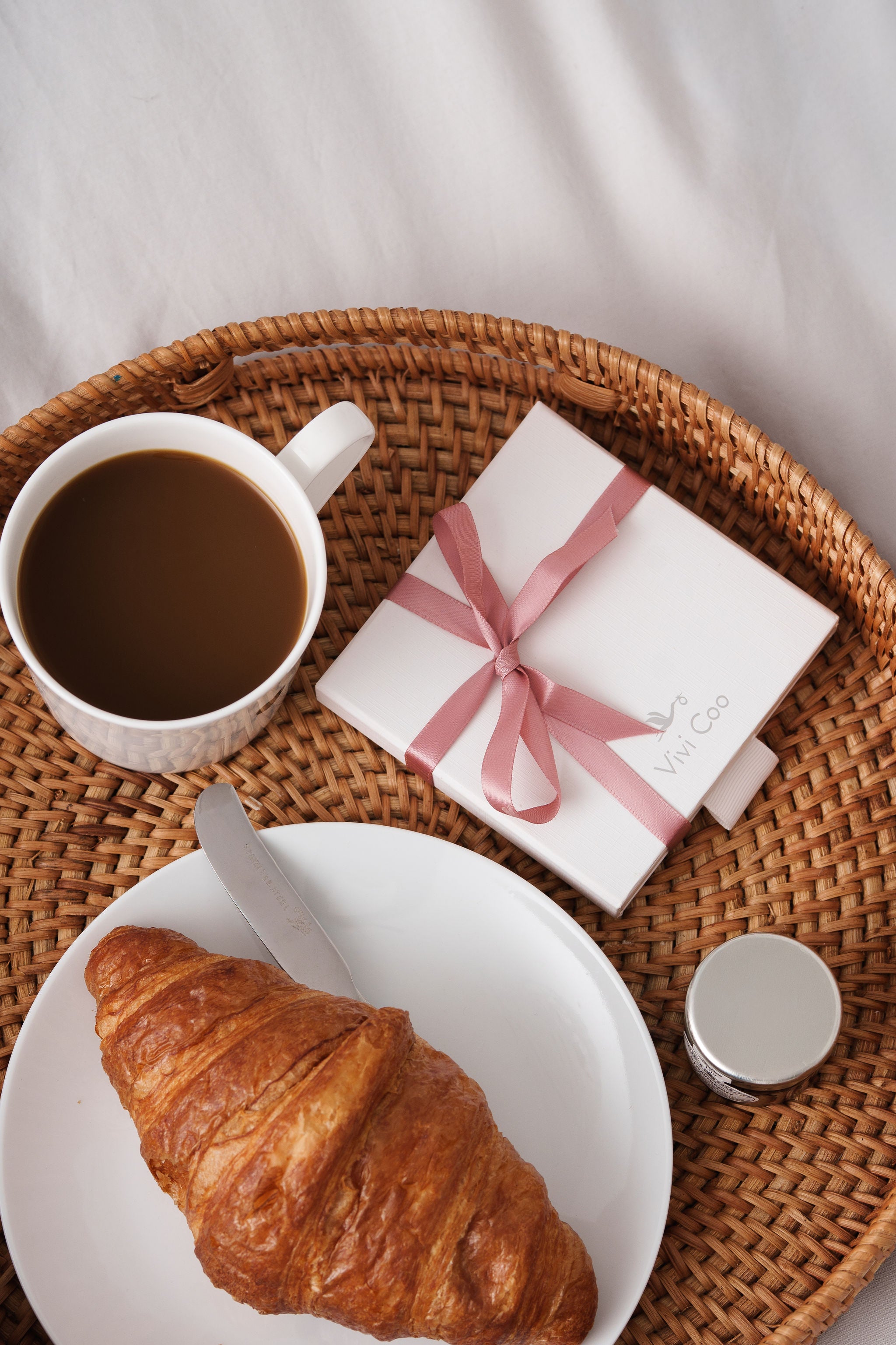 Vivi Coo jewellery gift box styled on a breakfast tray with coffee and a croissant, elegant gifting scene.