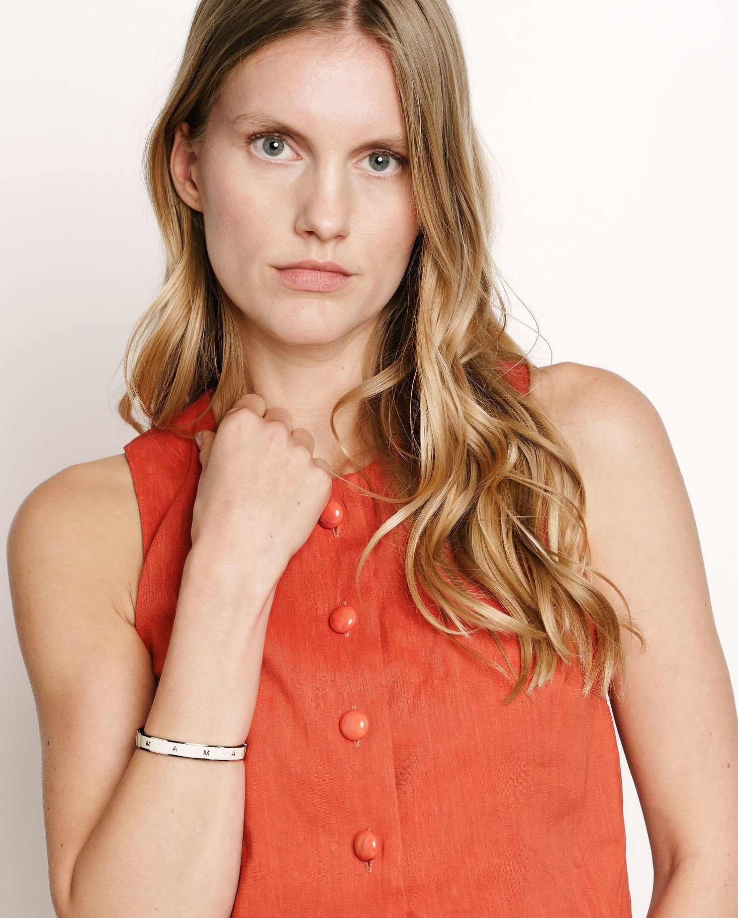 Proud mother wearing her Vivi Coo Mama bracelet, motherhood jewellery